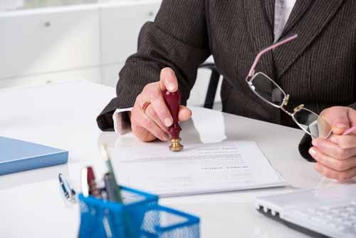 A notary public works on a document
